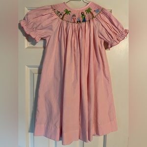 Smocked nativity scene pink dress.